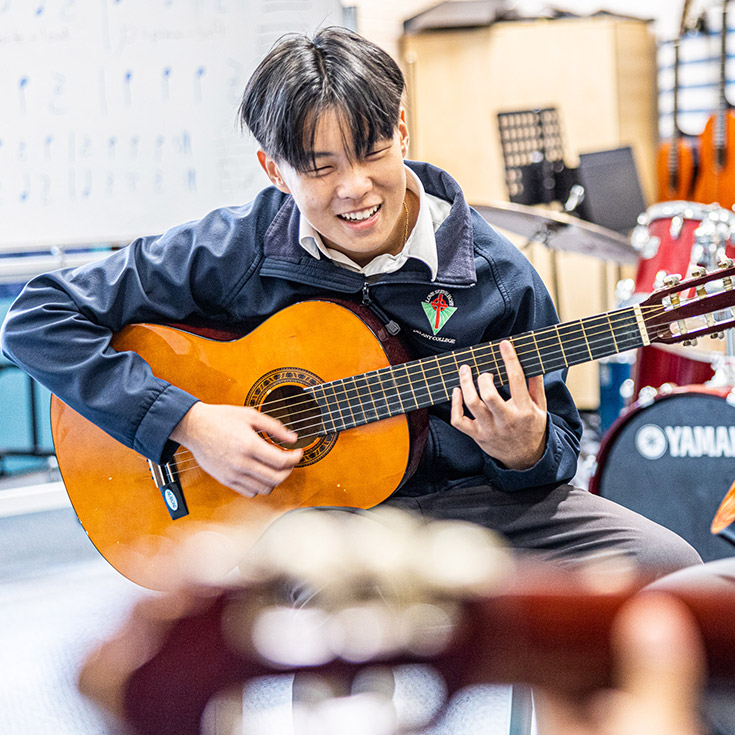 Learning guitar at Delany Catholic College Granville