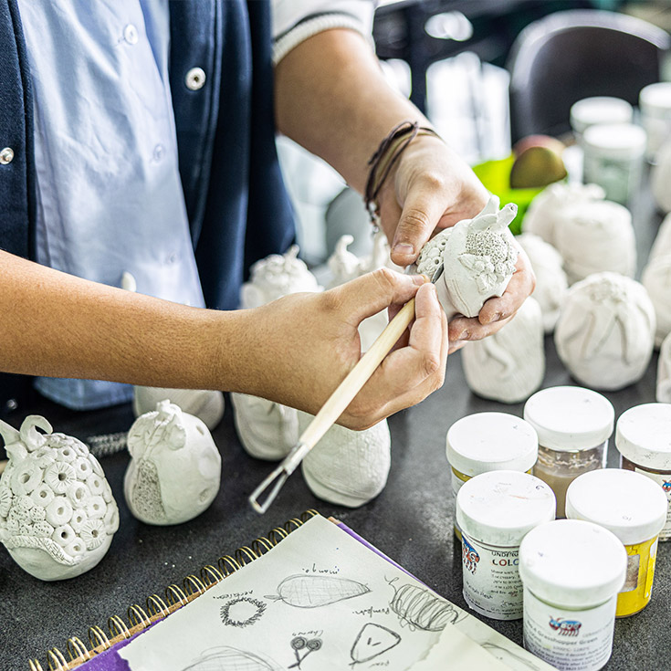 Visual arts student carving plaster at Delany Catholic College Granville