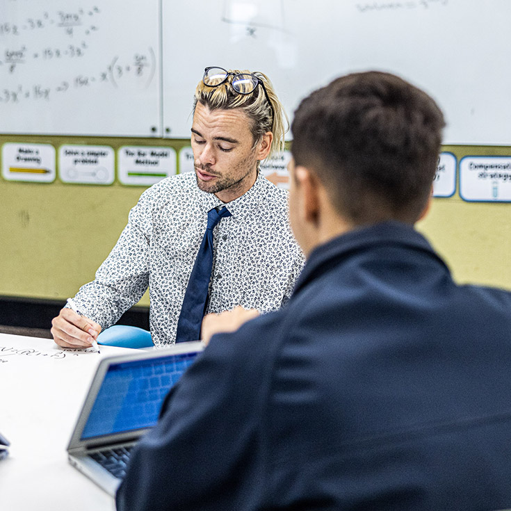 Teacher helping student at Delany Catholic College Granville