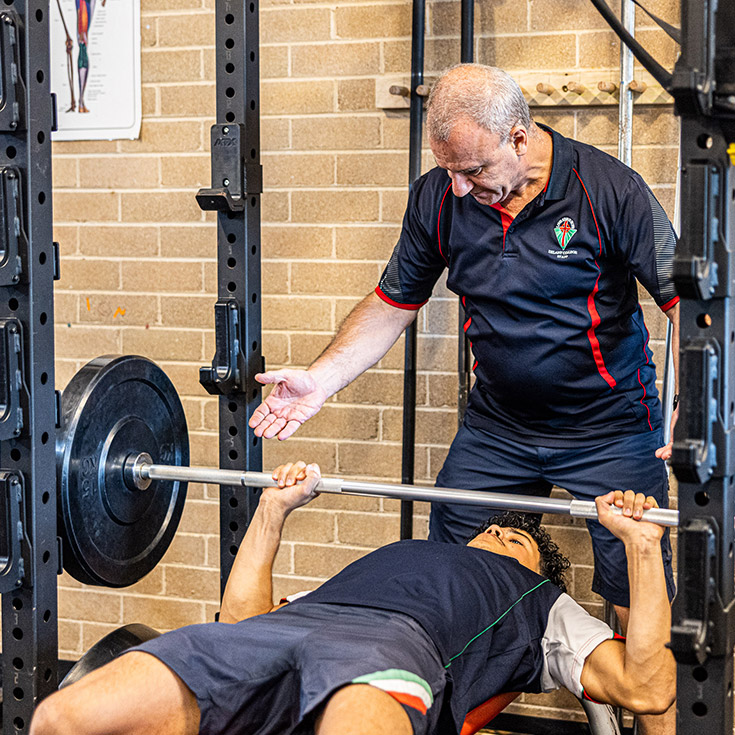 PDHPE teacher with student at Delany Catholic College Granville