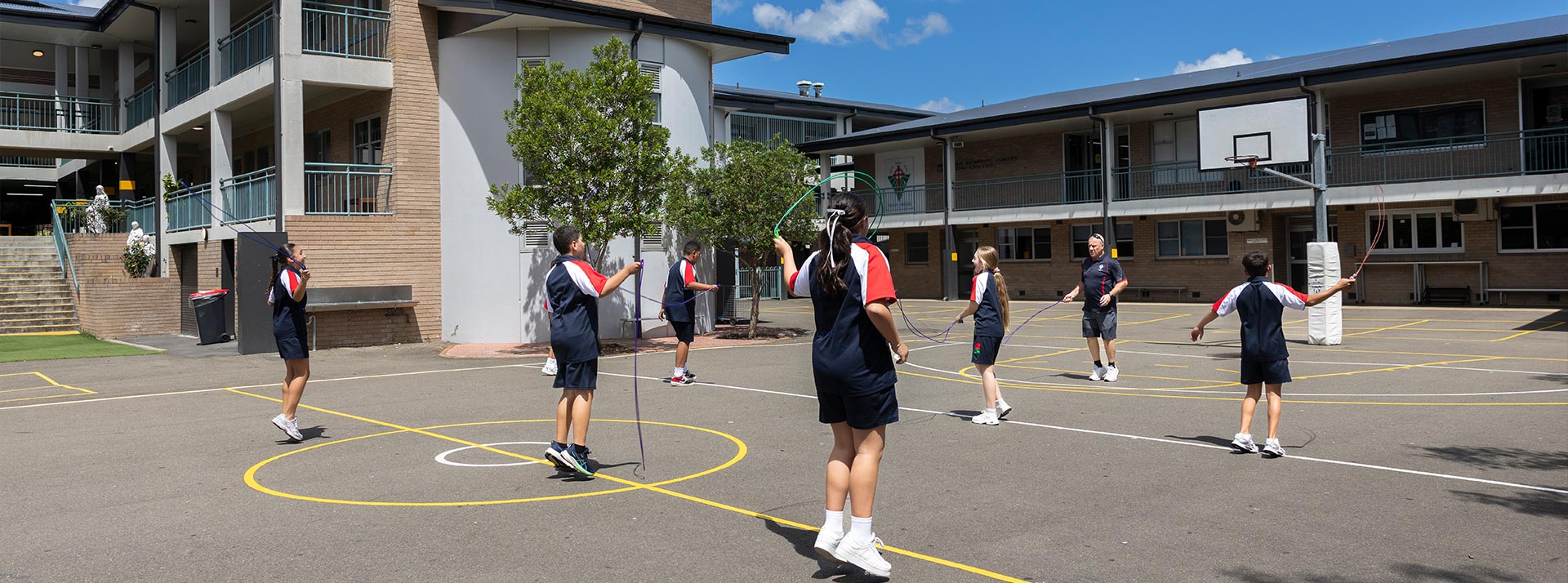 Delany Granville students in sports polos playing skip rope