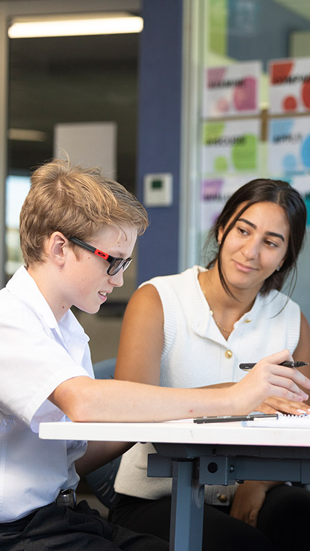 Delany College Granville teacher assisting students in classroom 