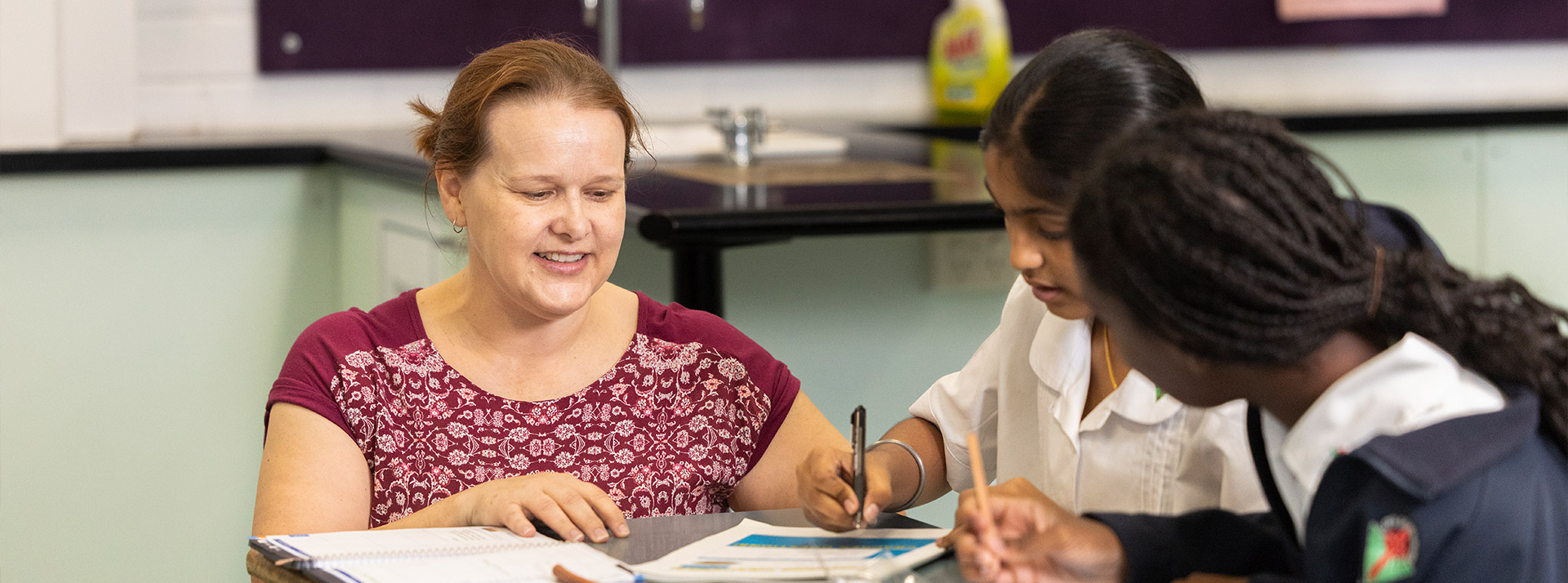 Delany College Granville teacher assisting students in classroom 