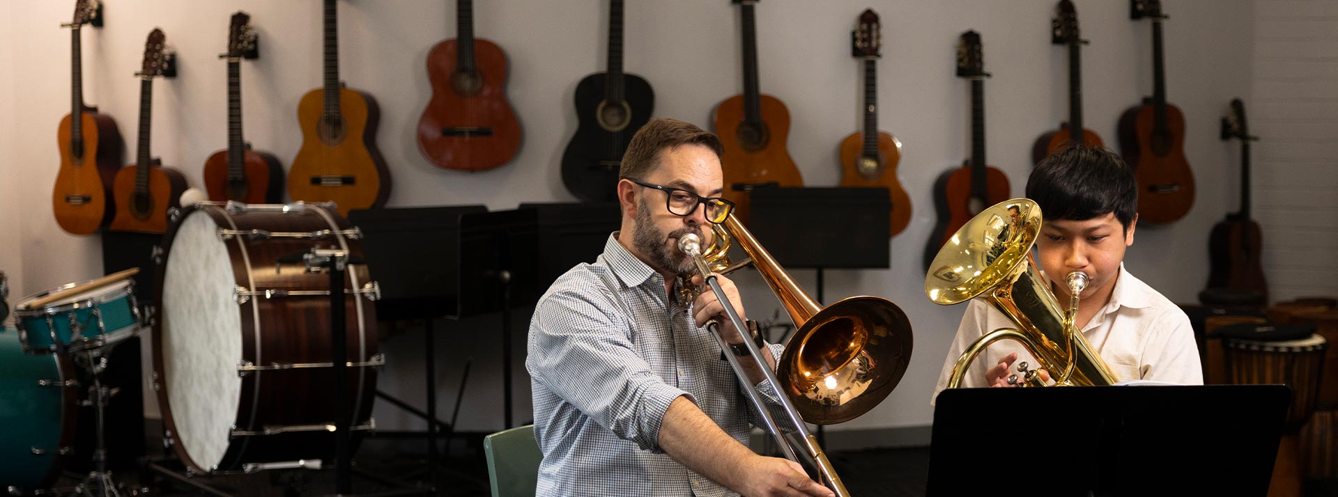 Music lessons at Delany Granville. The music teacher is giving a lesson on brass section