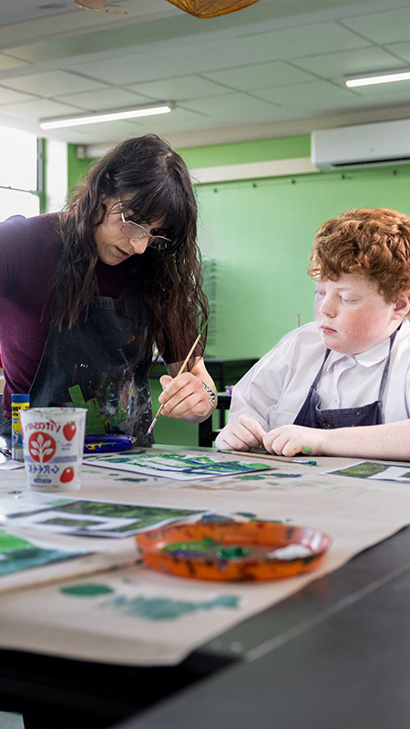 Delany Granville Art teacher assisting student