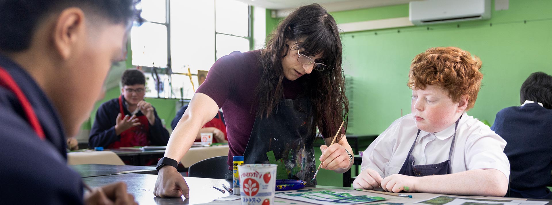 Delany Granville Art teacher assisting student