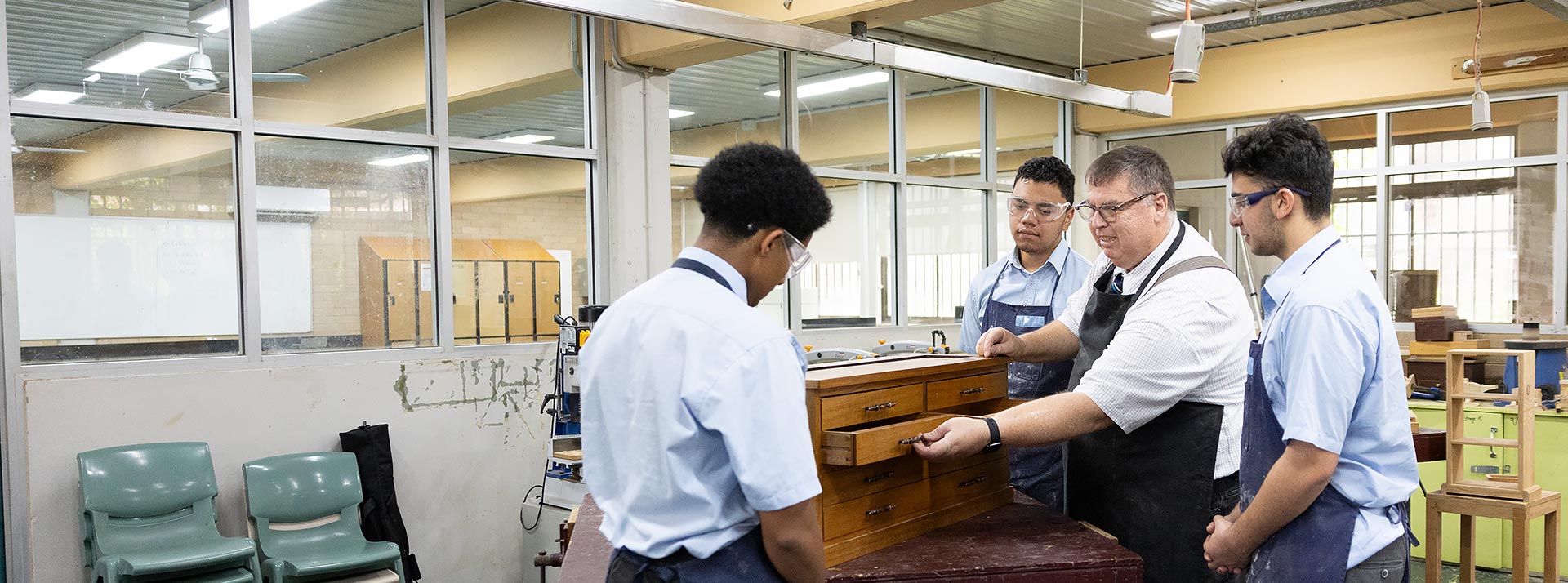 Woodwork teacher assisting Delany College Granville students with their woodwork project