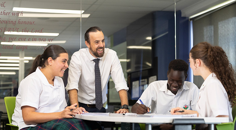 Delany College Granville teacher assisting students in classroom 