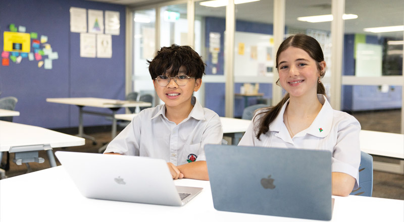  Delany Granville students in class, working off of MacBooks