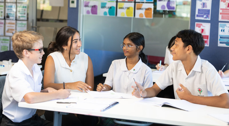 Group of students working with teacher
