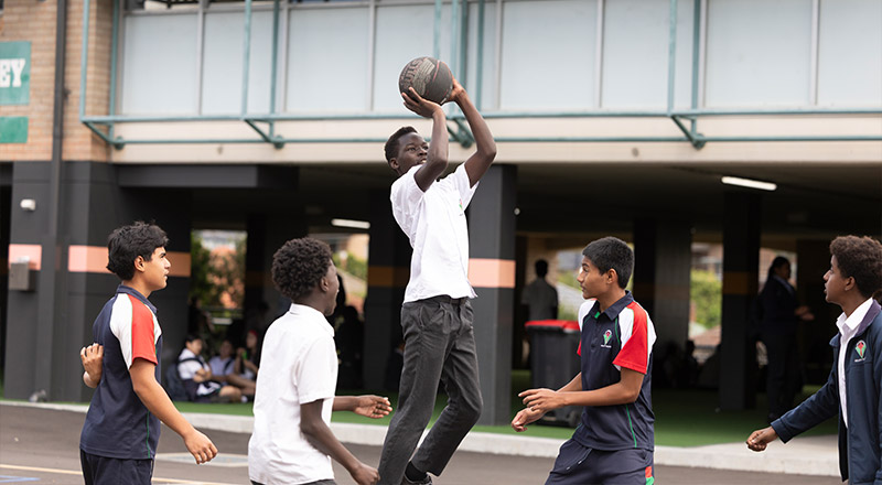 Delany Granville students playing basketball on outdoor court