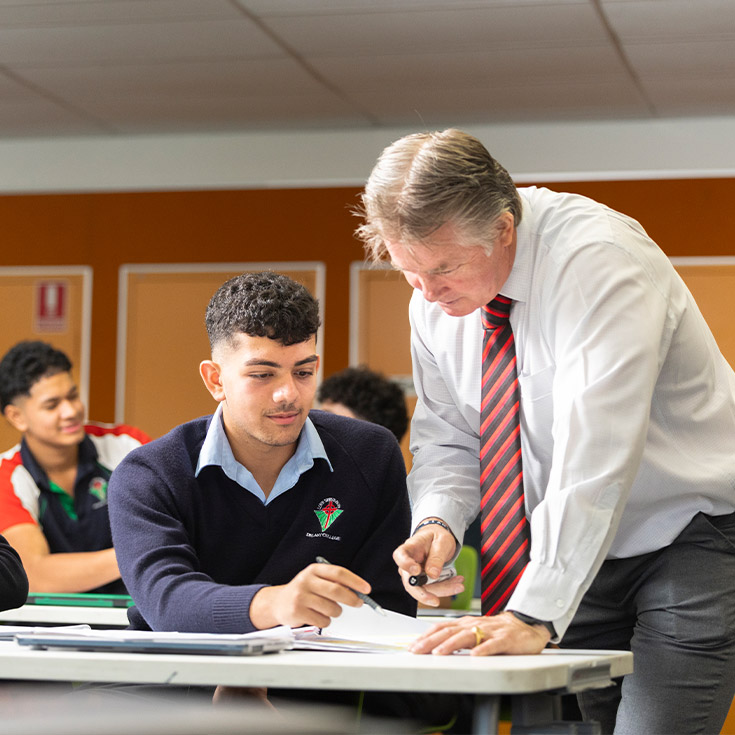Delany College Granville students in class being assisted by teacher