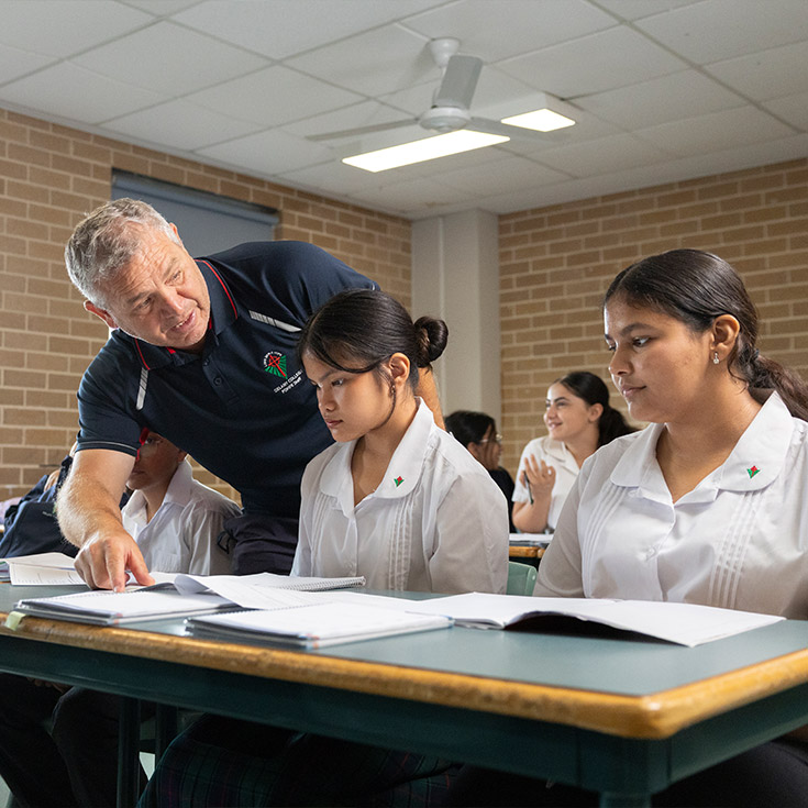 Delany College Granville teacher assisting students in classroom 