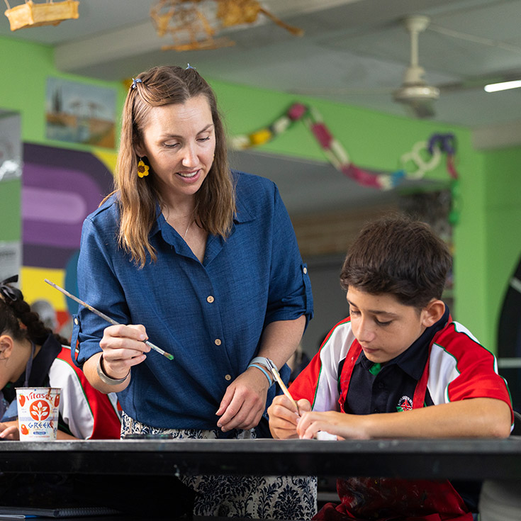 Delany College Granville teacher assisting students in classroom 