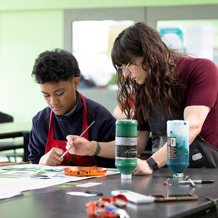 Delany Granville Art teacher assisting student in class