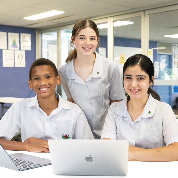 Three Delany Granville students working from their laptops
